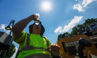 A construction worker drinks water as temperatures soar in Atlanta on June 24.