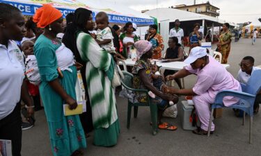 A health employee prepares to give a malaria injection to a child during the official ceremony for the launch of a malaria vaccination campaign in Ivory Coast.