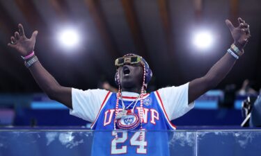 American rapper Flavor Flav shows his support during the Women's Preliminary Round Group B match between Team Italy and Team United States on day five of the Olympic Games Paris 2024 at Aquatics Centre on July 31