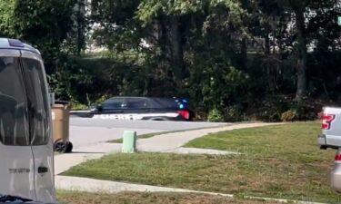 A line of cars park about half a mile from Apalachee High School.