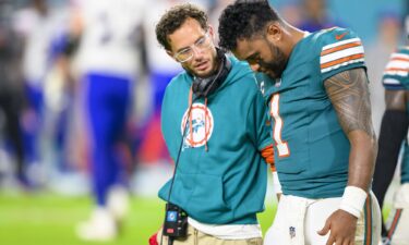 Miami Dolphins quarterback Tua Tagovailoa (right) walks off the field with head coach Mike McDaniel during the game against the Buffalo Bills.