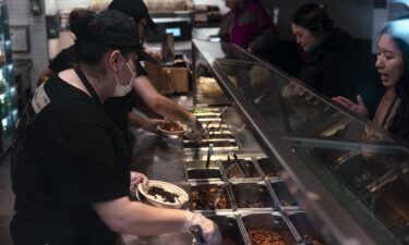 Workers serve food inside a Chipotle restaurant in New York on January 12