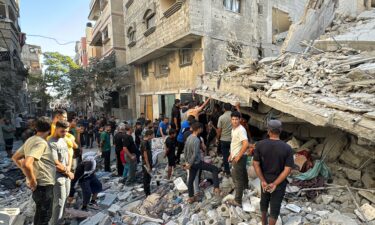 Palestinians inspect the damage after an Israeli airstrike the previous night in Beit Lahia