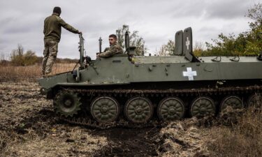 Two Ukrainian army mechanics repair a broken MT-LB (light armored multi-purpose towing vehicle) in the Donetsk region in Kharkiv