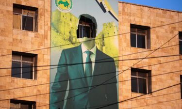 A view shows a damaged poster of Syria's President Bashar al-Assad in Aleppo after the Syrian army said that dozens of its soldiers had been killed in a major attack by rebels who swept into the city on November 30.