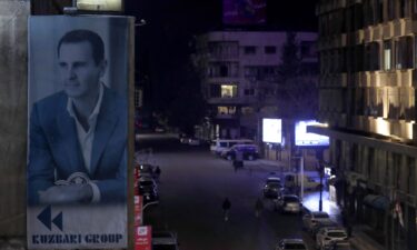 A portrait of Syrian President Bashar al-Assad is seen on a building in Damascus