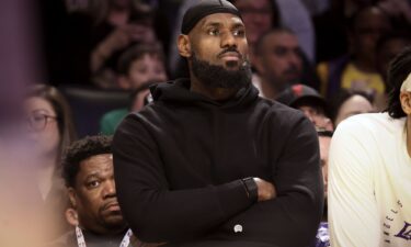 Los Angeles Lakers forward LeBron James watches from the bench during the first half of Sunday's game against the Portland Trail Blazers.