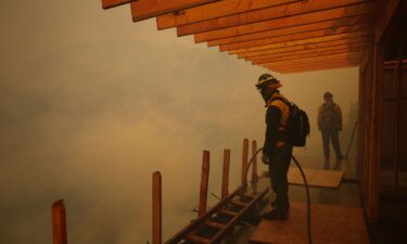 Firefighters monitor the advance of the Palisades Fire in Mandeville Canyon in Los Angeles on January 11.