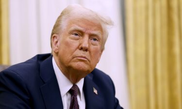 US President Donald Trump speaks to reporters after signing a series of executive orders in the Oval Office of the White House on January 23 in Washington