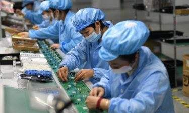 Employees work on a circuit board production line at the workshop of Anhui Shixin Electronic Technology Co LTD in Fuyang