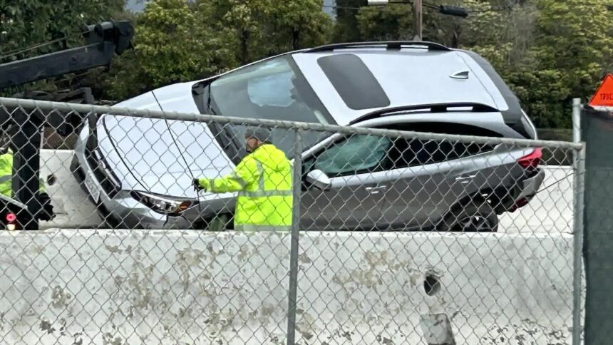 Car traveling on Hwy 101 wedged stuck in-between K-rails