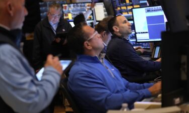 People work on the floor at the New York Stock Exchange on March 4.