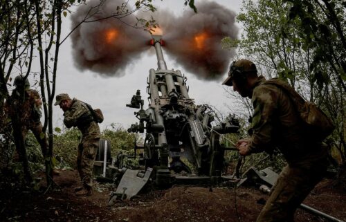 A file photo shows Ukrainian service members fire a shell towards Russian position in Kharkiv Region