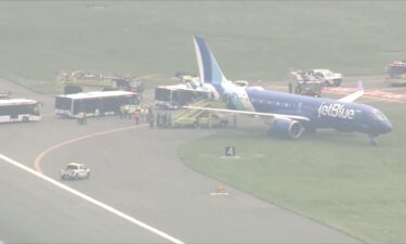 A jetBlue plane is seen off the runway at Boston Logan International Airport on June 12