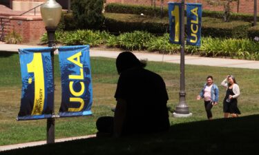 A student rests in the shade on the UCLA campus in Los Angeles on August 7.