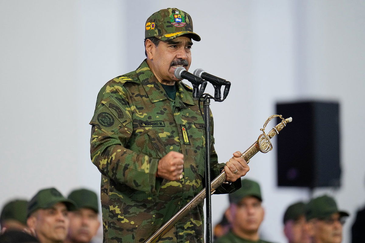 Venezuelan President Nicolas Maduro grasps a sword during a government-organized civic-military rally in Caracas